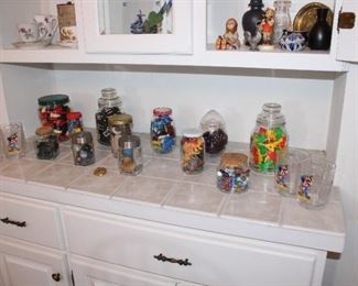Game pieces and vintage toys and rocks and marbles in glass jars