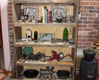 Old barnwood shelf filled with treasures! 1913 porcelain Michigan License Plate, collection of grinders and antique sausage stuffers, cast iron chicken fryer, treasures abound throughout the house!