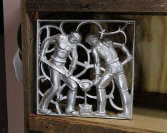Large Decorative cast aluminum plaques of two men pouring molten metal in to mould