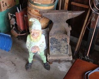 A LARGE Cast Iron gnome next to the Antique Anvil used by Muskegon Community College in its early days when it was in the Hackley School Building (later the Board of Education) in downtown Muskegon.  