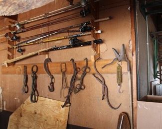 Collection of antique ice tongs and more old fishing poles