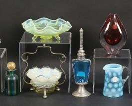 26	Lot of Glass Items Including Art Glass	Seventeen glass pieces including silverplate and  ruffled glass condiment dish, three ruffled dishes, Fenton style creamer, two painted tumblers, Orrefors signed art glass vase, four perfume bottles, hobnail milk glass bottle, three painted glasses, one salt, two painted Bohemian cabinet vases. Scratches and paint loss, crack in one tumbler. Hobnail bottle 6 1/4"H.

