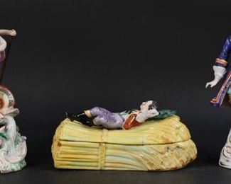 34	3 Chelsea or Samson Porcelain Figures	"3 English porcelain figures. Chelsea or Derby figure of Neptune with dolphin on bed of seaweed and shells. Chelsea or Samson figure of a gentleman with mask. Gold anchor mark on reverse of base. Lidded box of a man sleeping on a bundle of hay or wheat, possibly German. Losses and chips to Neptune's crown, tail of dolphin, and seaweed. Original trident replaced with wooden one affixed with glue at base, with top of trident broken off. Repairs to Neptune's left arm and right foot. Repairs and chips to right arm of gentleman. Arm is still loose in place. Chips and crack to lid of sleeping man on wheat. Light pitting to surface of wheat.   

Gentleman figure: 9 1/2"" H x 4 1/2"" L x 3"" W"
