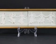 83	Jasperware Plaque & Pair Royal Doulton Jugs	English porcelain lot including green Jasperware plaque of dancing maidens 3 3/4" x 13 1/4" (with frame 4 5/8" x 14 1/2"); pair of Royal Doulton jugs - Charles Dickens The Pickwick Papers The White Hart Inn at Southwark and Old London, larger 5 3/8"H. Chips and losses to frame on plaque, line in glaze on Old London jug.
