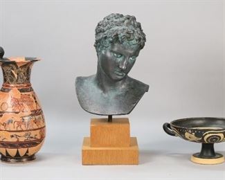 95	Reproduction Greek Pottery & Bust	2 pieces reproduction museum copy Greek pottery. Kylix, labeled "Kylix-Cup Circa 520 BC London Hand Made in Greece" and "No. 96 Epiktetos Painter, Internal: Horseman, Front and Reverse: Armed Satyr between eyes", 4 1/4"H x 8 1/2"-diameter; Olpe jug, 13 1/8"H. With a plaster bust Ephebe of Marathon, 16 1/2"H including wooden stand. Flakes and losses to painted decoration on both vessels; chips to hair, shoulder and back on bust.
