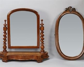 100	Two Victorian Mirrors	"Two Victorian mirrors, a shaving mirror on barley twist posts, and an oval form wall mirror with acanthus motif. Late 19th century. Desilvering to surfaces of both mirrors. Nicks and marks to wood of oval mirror. Marks, cracks, losses to veneer, and scratches throughout frame of shaving mirror. Scratches and nicks to wood of base of shaving mirror. Posts and frame of shaving mirror are not completely secured.

Shaving mirror: 22 1/4"" W x 9 1/4"" D x 22 1/8"" H. Oval mirror: 23 7/8"" H x 14 3/8"". W"
