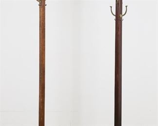 106	Two Mission Arts and Crafts Coat Trees	"Two Mission Arts and Crafts coat trees. American, early 20th century. Oak, four brass hooks to each tree. Loss wood to top of shortest coat tree. Scratches and marks to wood throughout posts of both trees. Chips to edges of feet of tallest coat tree. Scuffs, chips, and wear to wood of feet of shorter coat tree.

22 1/2"" W x 22 1/4"" W x 70 1/8"" H. Shorter coat tree: 18 7/8"" W x 19 3/4"" D x 64 3/4"" H."
