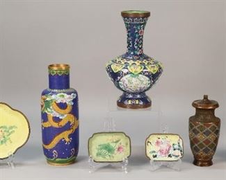 139	7 Piece Grouping of Chinese Enamelware	"Grouping of 7 pieces of Chinese enamelware. 3 cloisonne vases, a champleve vase, and three trays decorated with Chinese motifs. Trays marked ""CHINA"" on underside. Lines, cracks, and chips to two smallest trays. Champleve vase is drilled at bottom and fitted with threading on top. Scratches, pitting and losses throughout surface of champleve vase. Chips to surface and oxidization to metal rimmed base of widest vase. Wear and dirt throughout all pieces. 

Tallest piece: 9"" H x 2 1/2"" diameter of base"

