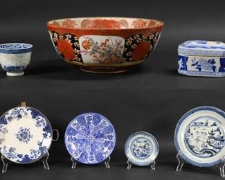 144	7 Pieces Chinese & Japanese Porcelain	"7 pieces porcelain. 6 pieces blue and white Chinese porcelain including 2 Canton plates, 10""-diameter and 5 5/8""-diameter; export style plate, 8 3/8""-diameter; export style hot water plate, 9 3/8""-diameter; lidded box 4""L x 2 1/2""H; and a rice grain cup with blue six character Guangxu mark, 2 1/4""H; Japanese Imari bowl, 4""H x 9 5/8""-diameter.

Line to larger Canton plate, lines to base of Japanese bowl, chip to rim of rice grain cup, firing imperfections and discoloration to rice grain cup."
