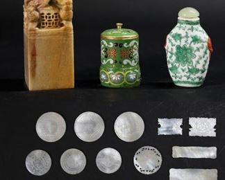 148	Chinese Loo Chips, Snuff Bottles, Seal	Lot of Chinese decorative items including 19 Chinese carved mother-of-pearl Loo gaming tokens / chips, largest 2 1/2"L, porcelain snuff bottle with hardstone lid and red 3 character mark , 2 5/8"H; cloisonne jar, 2 1/8"H; carved hardstone foo dog seal, 4 1/2"H.
