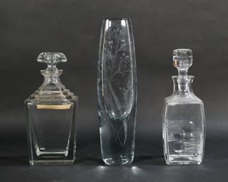 150	Art Glass Vase & 2 Decanters	Stromberg art glass vase with etched decoration, 13 1/4"H; Atlantis crystal decanter, 10 1/2"H; Florentine crystal decanter, 10 1/4"H. Roughness to end of stopper on Florentine decanter, scratches to undersides of all.
