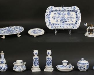 194	11 Pieces Meissen Blue Onion Porcelain	"11 pieces Meissen Blue Onion pattern porcelain. Footed platter, candle holder, pair of candlesticks, trivet, nutcracker, lidded sugar bowl, 2 bottles, candle warmer, all with blue crossed swords Meissen marks (marks on footed platter and trivet with two slash marks). With a small carving platter, unmarked. Footed platter 2 1/4""H x 10 3/8""L, nutcracker 4 3/8""H closed.

1 candlestick chipped on rim and 1 chipped on underside of base, nutcracker repaired on both sides, finial repaired on sugar bowl lid, stopper frozen on smaller bottle, minor chips to flower finials on bottles, warmer repaired on top and on rim."
