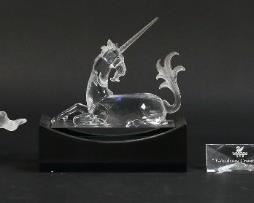200	Swarovski Crystal 'Fabulous Creatures' Figurines	Set of three Swarovski figurines titled "Fabulous Creatures". Includes dragon with stand, unicorn with stand, Pegasus with matching plaque, and set title plaque. All figures with a Swarovski Swan maker's mark. Stand dimensions: 5 7/8" W x 2 3/4" D x 2" H. Some scratches on black unicorn stand.
