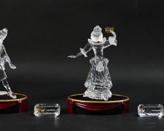 203	Swarovski Crystal 'Masquerade' Figurine Set	"Swarovski 'Masquerade' figurine set. Includes Pierrot, Columbine, Harlequin, corresponding title plaques, and three display stands. All figurines include a Swarovski swan maker's mark and original packaging.
Pierrot measures 3 3/4"" W x 3 3/8 D x 7 7/8"" H.
Some minor wear on the tops of the display stands."
