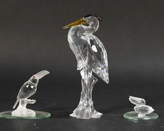 205	Swarovski Crystal Bird Figurines	Lot of three Swarovski figurines including heron, toucan, pelican, and two mirrored display plates. All figures with a Swarovski Swan marker's mark. Heron dimensions: 2 3/4" W x 2" D x 5 3/4" H.
