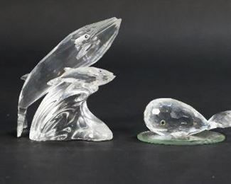 206	Swarovski Crystal Marine Animal Figurines	Lot of four Swarovski crystal marine animals. Includes 'Care for Me' edition whale duo, whale, tang fish, goldfish, and three small mirrored display plates. All figurines include a Swarovski swan maker's mark. Whale duo measures 3 1/2" W x 1 1/2 D x 4" H.
