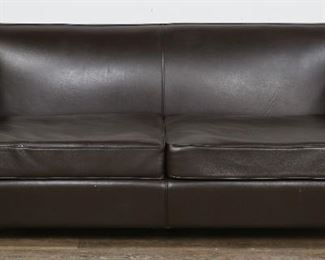 218	Contemporary Dark Brown Leather Couch	"Contemporary dark brown leather couch. 21st century. 2 leather throw pillows are included. No labels or identifying marks are present. Scratches and wear to seat cushions. White scuffs to front of left seat cushion and to front of couch. Losses to leather on inner edge of left arm of couch. Scratches to top of couch, light marks to left and right sides. Losses to leather on back edge of top.

33"" H x 76"" L x 38"" D"
