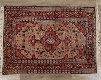 223	Persian Style Rug	"Persian style rug. 20th century. Floral motifs and fringed edges. Stains to rug next to one side of center medallion. Slight fading throughout rug. 

4' x 5' 5"""
