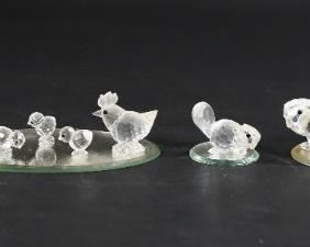 249	Lot of 9 Swarovski Crystal Animal Figurines	Lot of nine Swarovski crystal animal figurines. Includes 3 piece beaver family, 5 piece chicken family, duck, and four mirrored display plates. All figurines include a Swarovski swan marker's mark. Largest beaver measures 3 1/4" W x 1 1/2" D x 1 3/8" H.
