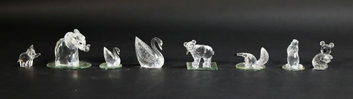252	Lot of 8 Swarovski Crystal Animal Figurines	Lot of 8 Swarovski crystal animal figurines. Includes two elephants, a koala bear, a groundhog, an anteater, a bear with trout, two swans, and five mirrored display plates. All figurines include a Swarovski swan or block logo maker's mark. Small elephant figurine is missing one ear. Large elephant measures 2 1/2" W x 1 1/2" D x 2 1/4" H.
