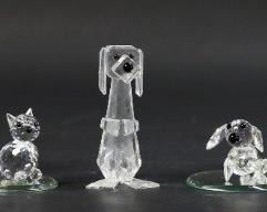 255	6 Swarovski Crystal Figurines Cats & Dogs	6 Swarovski crystal figurines, cats and dogs. Cat, standing cat, tall cat, Pluto dog, Dachshund, large Dachshund. Largest cat 2 7/8"H. All with Swarovski swan marks except small Dachshund with S mark. All with original boxes. Roughness and fleabites to feet on standing cat
