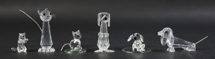 255	6 Swarovski Crystal Figurines Cats & Dogs	6 Swarovski crystal figurines, cats and dogs. Cat, standing cat, tall cat, Pluto dog, Dachshund, large Dachshund. Largest cat 2 7/8"H. All with Swarovski swan marks except small Dachshund with S mark. All with original boxes. Roughness and fleabites to feet on standing cat
