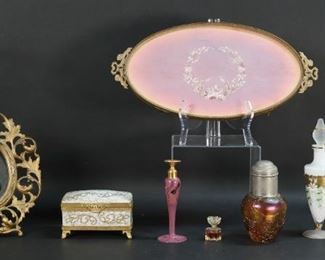 261	Lot of Perfumes & Dresser Items	"Lot of vanity and dresser items, including matching Bohemian glass perfume and box, DeVilbis art glass perfume, iridescent art glass bottle, Oscar de la Renta perfume (partially full), Limoges hand painted porcelain jewelry box for Saks Fifth Avenue, gilt metal mirror, gilt metal dresser tray with embroidered design. DeVilbis bottle 6""H

Hinge broken on Limoges box, losses to decoration on lid of DeVilbis bottle, fading to fabric embroidery on tray."
