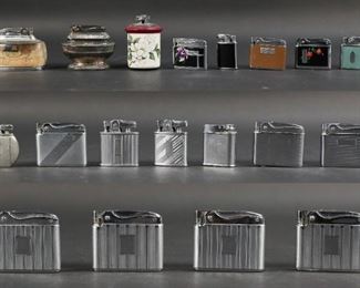 264	Lot of 19 Ronson Lighters	Collection of 19 Ronson lighters with 6 protective pouches and one original box. Includes three table lighters and pocket models such as 'Adonis', 'Standard', 'Princess', 'Perfu-Mist', and 'De-light'. Some corrosion on two lighters, five lighters have limited movement in the button mechanism, the porcelain on one table lighter is chipped on the bottom. All lighters are untested. 'Queen Anne' model table lighter measures 3 1/4" W x 1 1/2" D x 2 1/2" H.
