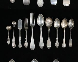 279	Lot of Coin Silver Flatware	Lot of coin silver, mostly spoons. Including serving spoons, set of 6 teaspoons, Lowell & Senter, J.E. Caldwell & Co., J.M. Freeman, Griffen & Son, T. Perkins, F.W. Macomber, Gerrish & Pearson, J. Hollister. 656 grams total. End of one spoon chipped.
