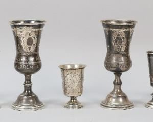 281	Lot of Sterling & 84 Silver Kiddush Cups	9 silver Kiddush cups. 2 sterling, 156 grams; 7 hallmarked Russian 84 (.875) silver, 180 grams. Largest 5 1/4"H. Bases dented on all, rims dented on 2 sterling cups.
