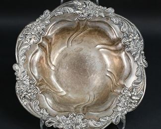 282	Meriden Sterling Bowl	Meriden sterling silver bowl with scroll and flower decorated rim. Meridan maker's mark. 2 1/4"H x 11 3/4"-diameter. 510 grams.
