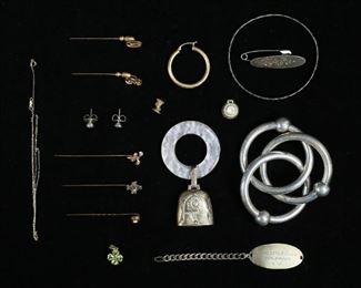 293	Lot of Silver & Gold Jewelry	Lot of silver and gold jewelry. Sterling silver including 2 rattles, bangle, nameplate on chain, pin, pendant, 85.9 grams total including stones, rattles; lot of gold including 5 14k stick pins, 6.5 grams including stones; pair of earrings, backs marked 18k, 2.3 grams including stones; single 14k earring .9 grams; 10k pendant 1.7 grams including stones; 14k chain .4 grams; gold crown 1.4 grams. Back replaced on silver pin, chain tangled.
