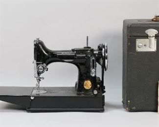 299	Singer Featherweight 22K Sewing Machine in Case	Circa 1930s Singer Featherweight model 221K sewing machine. Serial number AF250628. With foot pedal, case and accessories. Machine 15"L. Machine and foot pedal untested. Wear to case and light scratches to machine.
