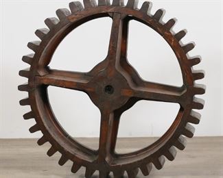 301	Industrial Wooden Gear Mold	"Industrial wooden gear mold. 20th century. ""290"" stamped on either side of gear and written on paint on spokes. Chips, scratches, losses, marks, and wear throughout wood of mold. 

5"" H x 32 1/8"" diameter"
