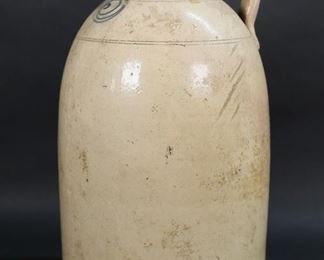 307	5 Gallon Stoneware Jug	5 gallon stoneware jug. 19"H x 11"-diameter at base.  Lines throughout, chips and roughness at rim, flake in 5.
