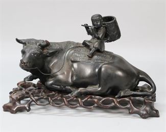 340	Japanese Bronze Boy & Water Buffalo	Japanese bronze of a boy atop a water buffalo. On a later wooden stand. Bronze signed on the underside. 12 1/2"L x 6 1/8"H.
