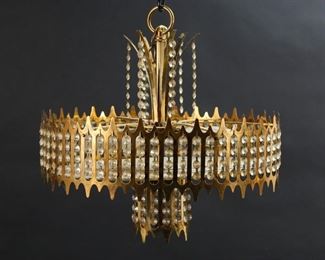 338	Modern Hollywood Regency Chandelier	Mid-century Hollywood Regency stye hanging fixture. Gilt metal with glass shade and crystal drops. 18 1/2"H (to top of ring), 18"-diameter.
