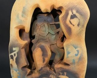 343	Steven Mayo Figural Art Pottery Sculpture	"Steven Mayo (American). 2001. Jazz players in center of form with stenciled musician motifs.  Signed and dated ""Mayo 2001"" on lower right corner. Line to surface on upper back of sculpture. Chips and losses to surface, with heavy chips and paint losses to edge of base. 

15 1/2"" H x 12"" L x 5"" W"
