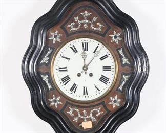 378	Napoleon III Mother-of-Pearl Inlaid Wall Clock	French Napoleon III wall clock. Ebonized wood, glass dial, mother-of-pearl inlays. 24"H x 18 3/4"W. Cracks to veneer above 12 and below 6, losses to mother-of-pearl at 4, chips to painting on face, scratches to veneer on case and chip along edge, crack and repair to case at 3 and repair to case at 1.
