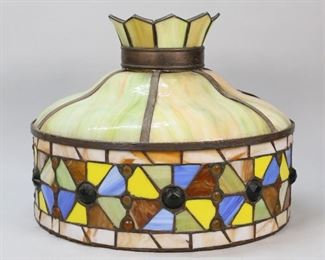 382	Leaded Slag Glass Hanging Fixture	Leaded and slag glass hanging fixture. Green slag glass panels with blue, yellow, brown, green and caramel leaded glass. 14 3/4"H x 18"-diameter. Crown does not sit flush at top of fixture.
