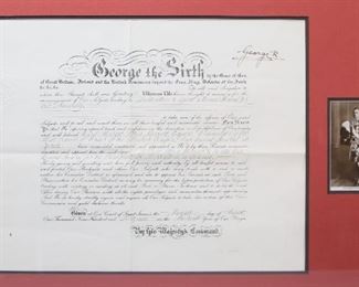 390	Signed George VI Military Document	Military promotion document. Dated 7 August 1949. Signed by King George VI. In framed display. Document 15" x 19 1/2" (with frame 22 1/2" x 32 1/4"). Creases to paper.
