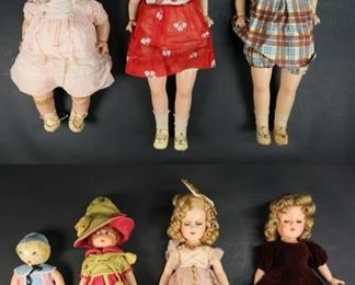393	7 Dolls Including Effanbee, Madame Alexander	Shirley Temple style doll composite with cloth body, composite baby doll with cloth body and sleep eyes, doll with plaid outfit composite with cloth body and sleep eyes, cloth doll with composite head, cloth rattle head doll, Madame Alexnder Sonja Henie ice skater composite doll, Effanbee composite doll. Shirley Temple style doll 23"H. Crazing to baby doll and tape residue on legs, crazing to doll with plaid outfit, damage to eyes on baby doll and plaid doll, Madame Alexander doll ice skate missing blade on one foot, crazing to fingers on Effanbee doll. Minor wear and discoloration to clothing on all.
