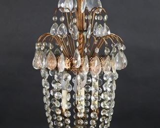 411	Hollywood Regency Chandelier	Hollywood Regency style gilt metal and crystal 4 light hanging fixture. 27 3/4"H (to top of ring), 12 1/4"-diameter.
