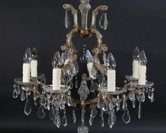 413	Baccarat Style Hollywood Regency Chandelier	Baccarat style 8 light crystal chandelier. 26 1/2"H not including bottom crystal, 30"-diameter. Some crystals mismatched, cords fraying, one bulb cracked.
