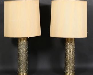 418	Pair of Brass Wallpaper Roller Style Lamps	Pair of cylindrical brass wallpaper roller style lamps with floral motif. Each 21 3/8"H to top of lamp fitting. Tears and staining to shades, metal ring at bottom of one shade detached.
