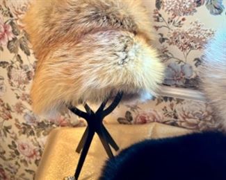 Several fur hats, including red fox