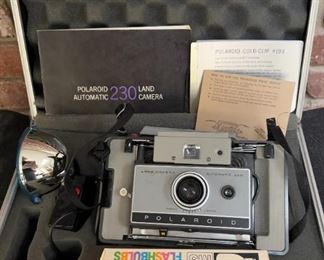 Polaroid land camera and accessories in metal carrying case