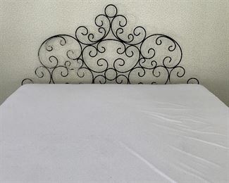 Welded metal scroll headboard, shown on king-sized bed