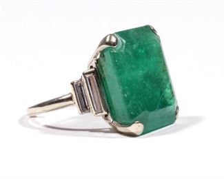 ANTIQUE 20CT COLOMBIAN EMERALD & DIAMOND RING | Having a central (approximately) 20ct natural emerald (17.76 x 15.36 x 9.37mm) flanked by four baguette diamonds in a platinum setting; accompanied by an AGL report identifying the stone as being of Colombian origin; 7.4g