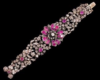 ANTIQUE DIAMOND & PINK SAPPHIRE BRACELET | Designed as a tapering openwork (tested to) 14k white gold bracelet with a central flower-head form section mounting round mixed cut pink sapphires and old mine cut and rose cut diamonds, the band made of six openwork links also mounting pink sapphires and diamonds and a matching conforming clasp section; 6-1/2, 82.8g